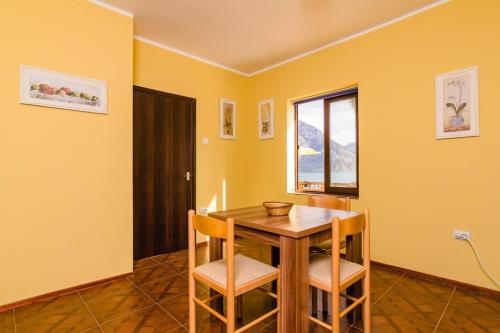 a dining room with a table and chairs and a window at Villa Strp in Risan