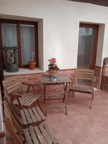 a patio with wooden chairs and a table and chairs at Apartamento Turístico El Empedrado de M&G in Colmenar de Oreja