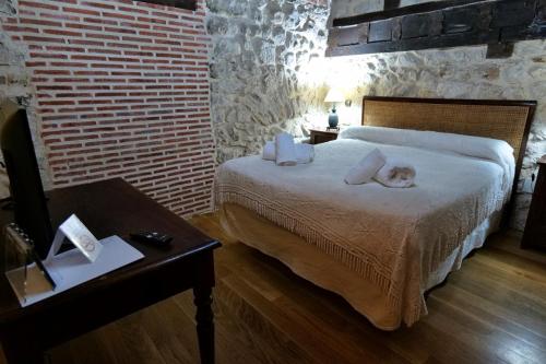 a bedroom with a bed with two pillows on it at La Sinagoga in Peñaranda de Duero