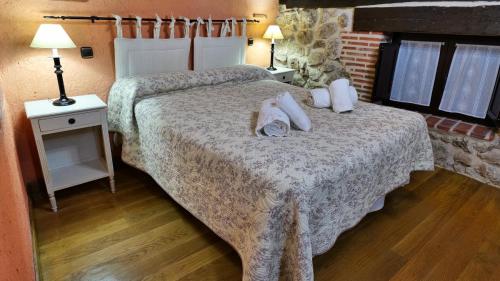 a dog laying on a bed in a hotel room at La Sinagoga in Peñaranda de Duero