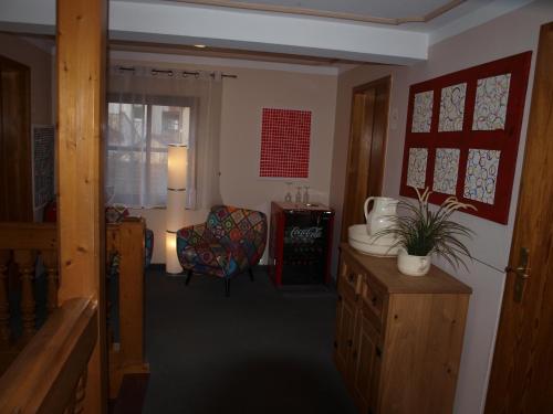 a living room with a chair and a table at Gästehaus Engelgasse Herzogenaurach in Herzogenaurach