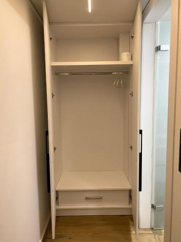 a walk in closet with white walls and white cabinets at NAFPAKTOS-luxury suite in Nafpaktos