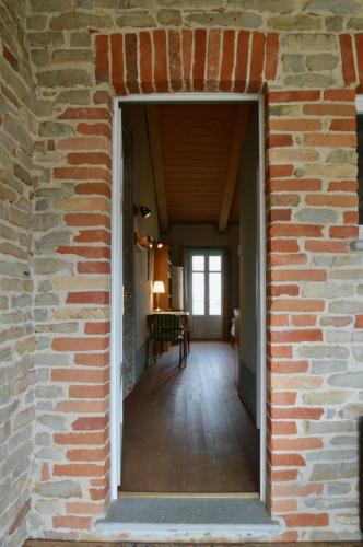 a brick wall with a doorway into a hallway at Ferrarotti in Clavesana