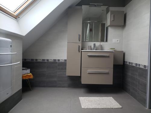 a white kitchen with a sink and a sink at Ile Cigogne in Fouesnant