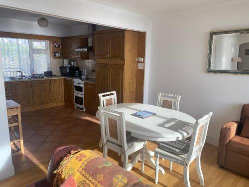 a kitchen and dining room with a table and chairs at ONeills Apartments in Ballyheigue