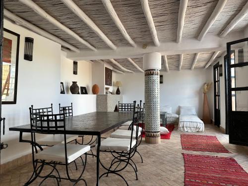 a dining room with a table and chairs at Riad Hugo in Marrakesh