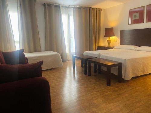Postel nebo postele na pokoji v ubytování Hostal Tres Soles