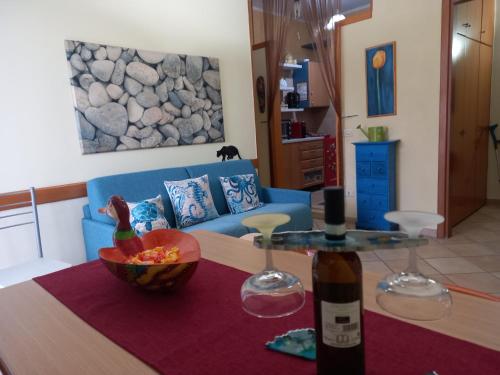 a living room with a table and a blue couch at Pozzuoli 100per100 Home in Pozzuoli