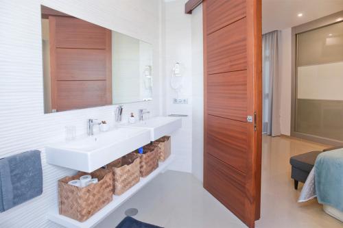 a bathroom with a sink and a mirror at Luxury Villa Punta Mujeres in Punta Mujeres