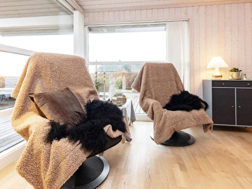 a living room with two chairs with blankets at 6 person holiday home in Karrebæksminde-By Traum in Karrebæksminde