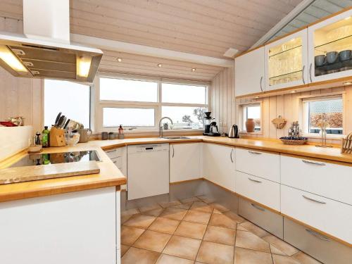 a kitchen with white cabinets and a sink at 6 person holiday home in Karrebæksminde-By Traum in Karrebæksminde