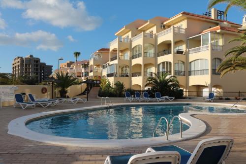 a swimming pool in front of a building at Golf View Apartment - stunning ocean view Golf del Sur in San Miguel de Abona