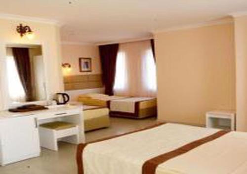 a hotel room with two beds and a bathroom at MIRAMOR HOTEL & Spa - ULTRA ALL INCLUSIVE SELECTION in Kemer
