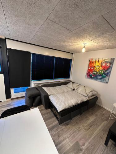 - un salon avec un lit et une grande fenêtre dans l'établissement RE-Seapark, à Hvidovre