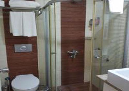 a bathroom with a shower and a toilet and a sink at MIRAMOR HOTEL & Spa - ULTRA ALL INCLUSIVE SELECTION in Kemer
