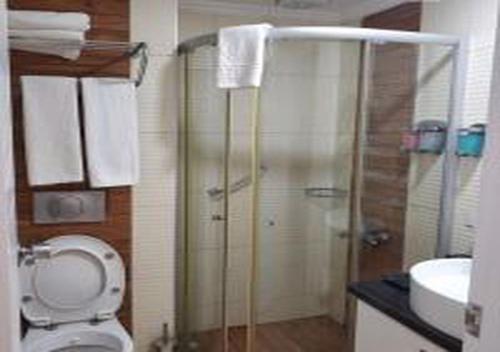 a bathroom with a shower and a toilet and a sink at MIRAMOR HOTEL & Spa - ULTRA ALL INCLUSIVE SELECTION in Kemer