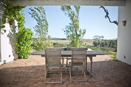 a table and chairs sitting on a brick patio at Hawksmoor House in Stellenbosch