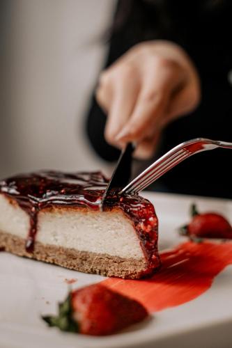 a person cutting a piece of cake with a fork at MY Smart in Yalova