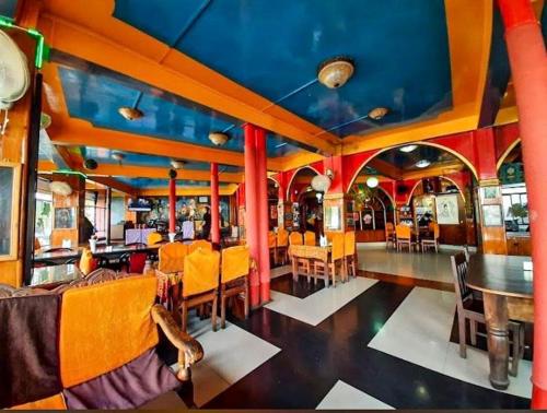 a dining car of a train with tables and chairs at King Thai Hotel and Restaurant in Kalimpong