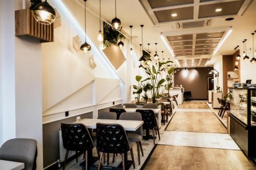 a restaurant with tables and chairs and a staircase at MY Smart in Yalova