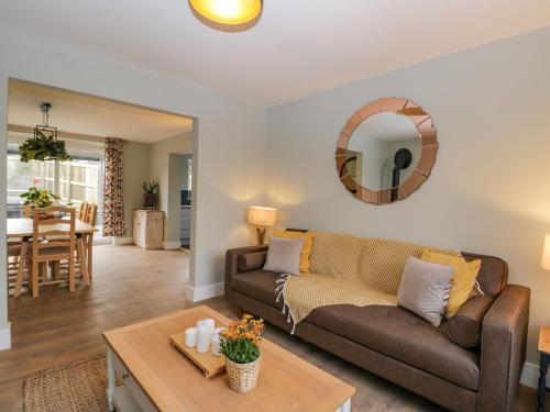 a living room with a couch and a table at Birch House in Corsham