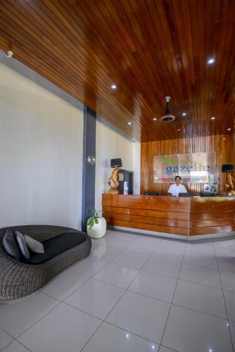 a lobby with a couch in the middle of a restaurant at Gazelle International Hotel in Kokopo