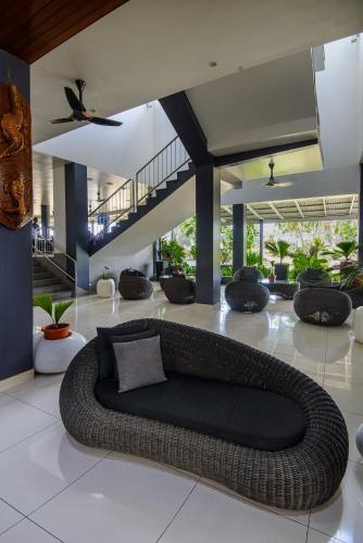 a room with a large couch in a building at Gazelle International Hotel in Kokopo