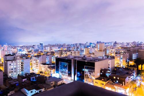 a view of a city at night with buildings at J&A Classic Hotel in Lima