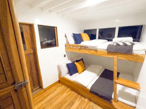 two bunk beds in a room with wooden floors at Komodo liveabord 3 Days 2 Night Depart every Friday-Sunday in Labuan Bajo