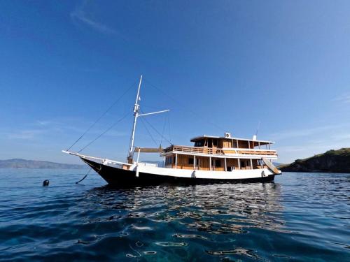 a boat sitting in the water on the water at Komodo liveabord 3 Days 2 Night Depart every Friday-Sunday in Labuan Bajo