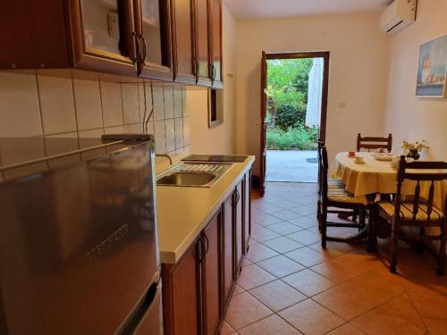 a kitchen with a sink and a table with a dining room at Villa Agava in Vrboska