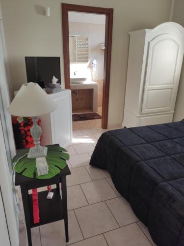 a bedroom with a bed and a table with a lamp at B&b De Mauro in Sava