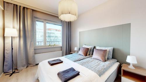 um quarto com uma cama grande e uma janela em Bellarova Apartments VI em Rovaniemi