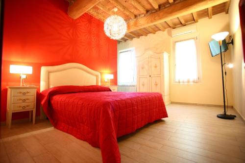a red bedroom with a bed with a red blanket at Villa Camurana in Medolla