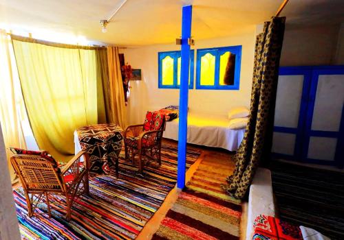 a bedroom with a bed and a table and chairs at Nubian studio in Aswan