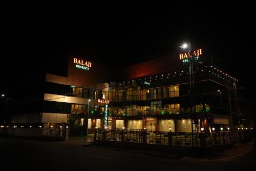 a building lit up at night with a street light at Balaji Regency Kanhangad in Kānnangād