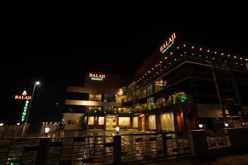 a building with lights on it at night at Balaji Regency Kanhangad in Kānnangād