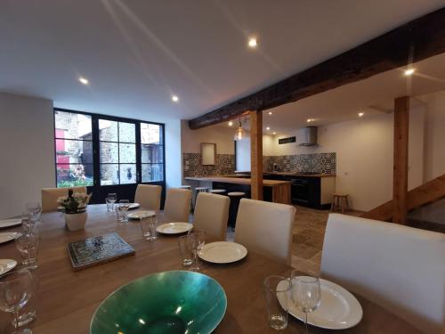 a dining room with a long table and chairs at Maison 12 personnes, Blesle in Blesle