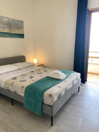 Ένα ή περισσότερα κρεβάτια σε δωμάτιο στο Casa in Salento sul mare con terrazze panoramiche