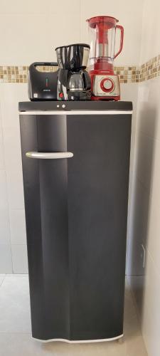 a black counter with a blender on top of it at Casa Sophia 17 ( Condomínio Aberto ) in Três Lagoas