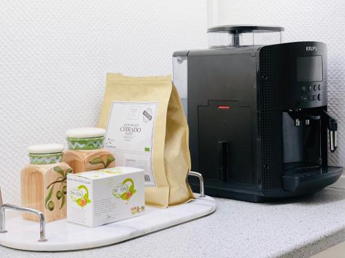 a counter top with a coffee maker and a microwave at Randers residence Sankt Andreas - 2 room apartment in Randers
