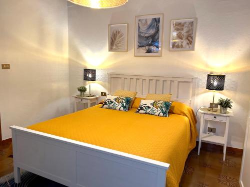 una camera con letto giallo con due comodini di Leaning Tower Suite a Pisa