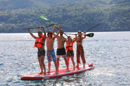 a group of people on a paddle board in the water at Residence Casa Coppa Appartamento Aster in Omegna