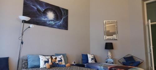 a living room with a couch and a picture on the wall at ANKER SILVER DREAM in Kaposvár