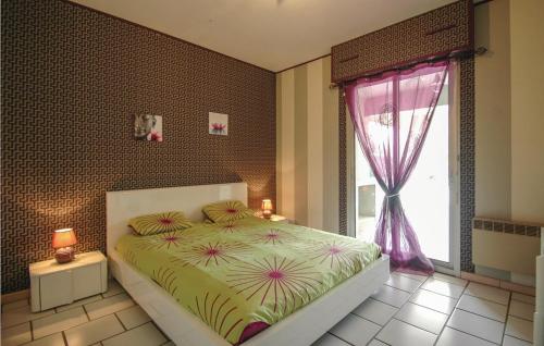 a bedroom with a large bed and a window at Cozy Home In Saint-vivien-de-medoc With Outdoor Swimming Pool in Saint-Vivien-de-Médoc