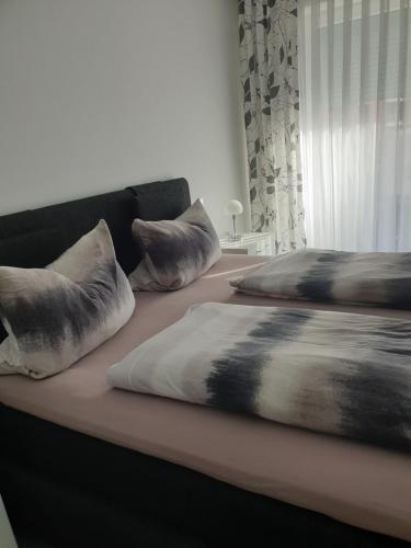 a couch with two pillows on top of it at Maje Am alten Binnenhafen in Emden