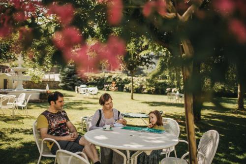 a group of people sitting around a table playing cards at Hotel Catalunya Park in Ribes de Freser