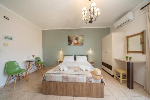 a bedroom with a bed and a table and chairs at Minas Apartments in Divarata