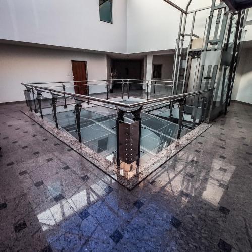 an empty room with a glass floor in a building at Americano in Brčko