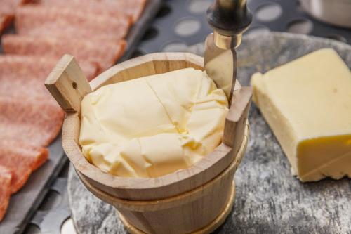 a container of butter on a table with cheese at Hotel Nordik Adults Only - Over 14 in Andalo